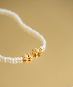 a necklace with pearls and a gold clasp